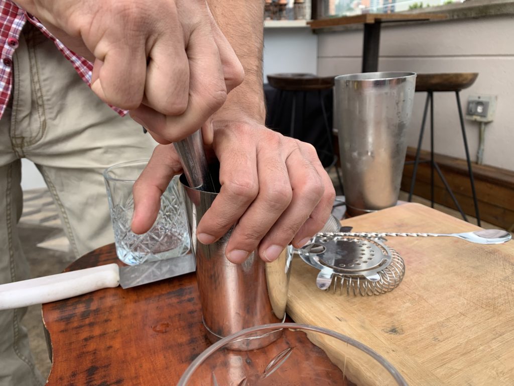 Barman showing how to mix drinks
