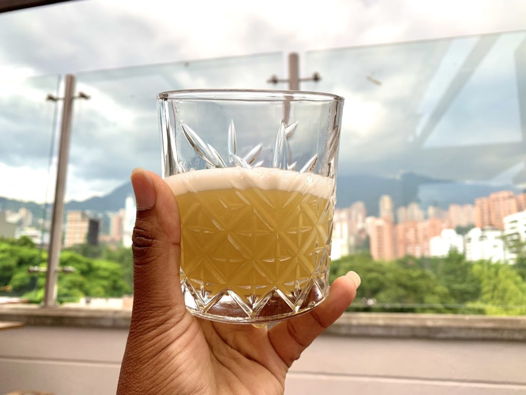 Person holding a cocktail in their hand