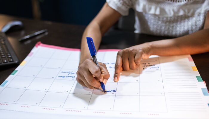 person writing all medellin events on his calendar
