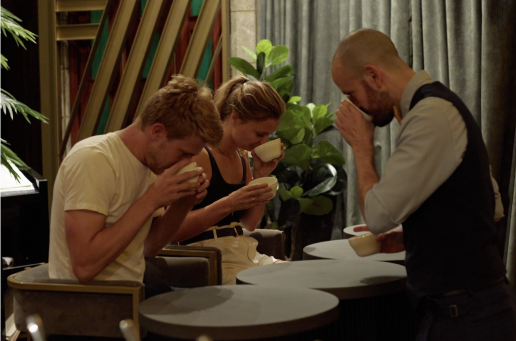 two tourists participating in the coffee tasting at the marquee