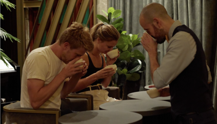 two tourists participating in the coffee tasting at the marquee